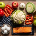 A colorful spread of kidney-friendly foods displayed on a wooden table