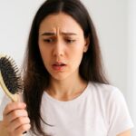 Causes of hair fall shown by hair on brush